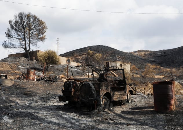 A burned vehicle in a burned area following deadly wildfires in Almocaizar, Almeria, Spain, July 12, 2026.