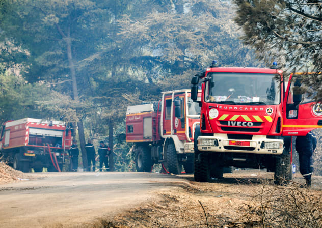 Illustrative: Firetrucks are pictured as firefighters attempt to extinguish a blaze at Chrea National Park, in the south of Algeria's Blida province, on August 27, 2025.