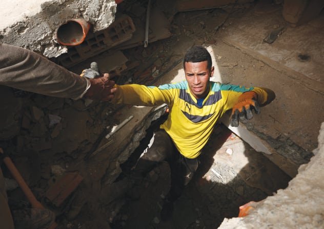 EARTHQUAKE AID: Hector Gonzalez is helped out of a tunnel in La Guaira, Venezuela, July 10; Illustrative.