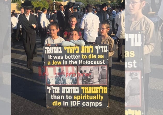 Haredi (ultra-Orthodox) children hold a sign reading that "Ir was better to die as a Jew in the Holocaust than to spiritually die in IDF camps," at a protest on Highway 4 near Bnei Brak, July 16, 2026.