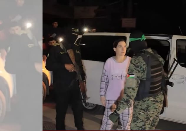 Rimon Buchshtab-Kirscht speaks to a Hamas terrorist as she is being released to the Red Cross in Gaza, November 28, 2023. 