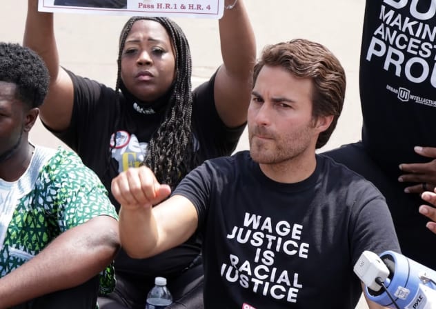 Kai Newkirk participates in civil disobedience to stop traffic during a “Freedom Friday March” protest at Ronald Reagan Washington National Airport, Aug. 6, 2021, Arlington, Virginia. 