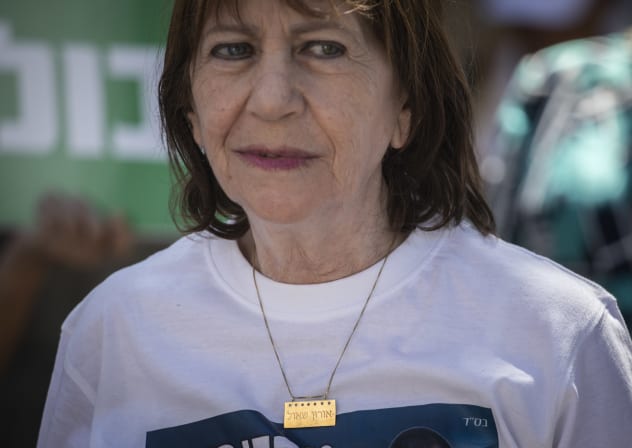 Zehava Shaul, mother of Oron Shaul, with supporters and family members of missing Israeli soldiers Oron Shaul and Hadar Goldin hold a protest outside the residence of Prime Minister Benjamin Netanyahu, on August 9, 2019. 