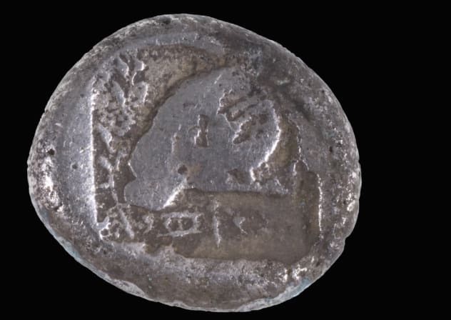 The ancient Cypriot silver coin dating to the mid-5th century BCE found on Ashdod's shore, July 26, 2026.