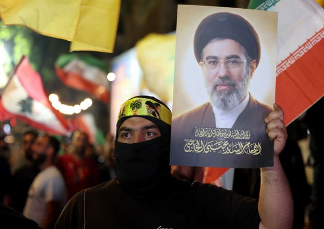 A supporter of Iran-backed terrorist group Hezbollah, holds a portrait of Iran's supreme leader Mojtaba Khamenei during an anti-US and anti-Israel protest in Beirut's southern suburbs on June 10, 2026.