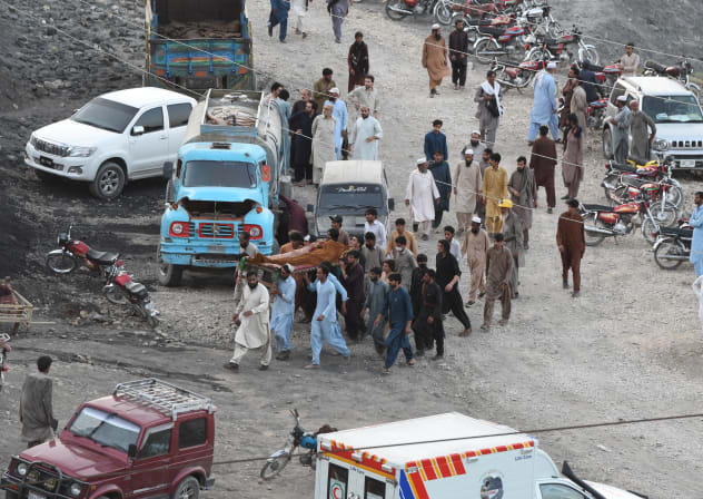 Coal miners and relatives carry the body of a miner after a coal mine collapsed in the Surange area, about 50 kilometres east of Quetta, on July 30, 2026.