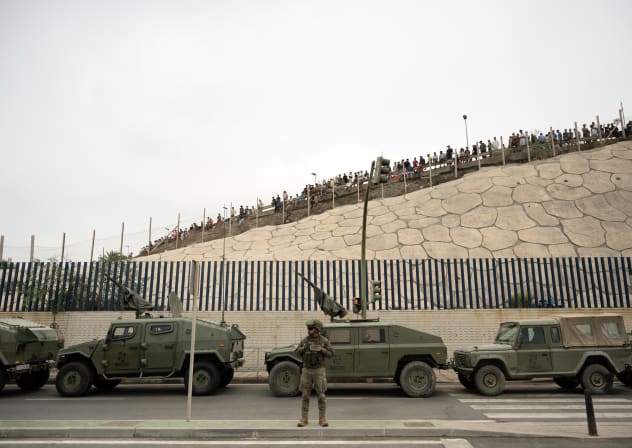 Spanish military personal patrol as migrants try to cross the border barrier with Morocco to enter Spain's north Africa's Ceuta enclave on July 31, 2026. 