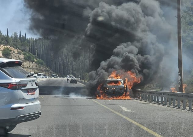 A vehicle is seen engulfed in flames on Highway 1 near the Shoresh Interchange on August 3, 2026.