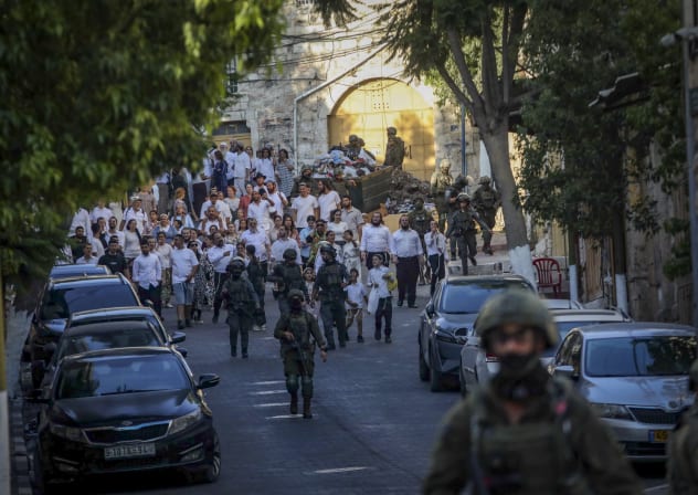 Israeli security forces guard as Jews tour in the West Bank city of Hebron, August 1, 2026