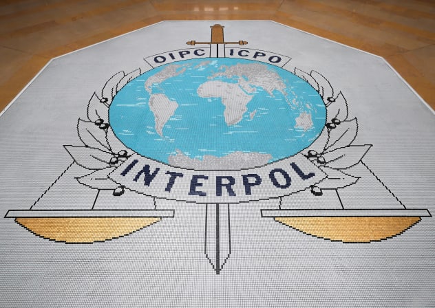 A sign at Interpol headquarters, where the International Criminal Police Organization, an intergovernmental body with 196 member countries, helps police worldwide work together through cooperation, intelligence-sharing and global alerts to combat cross-border crime, in Lyon, France, June 9, 2026. 