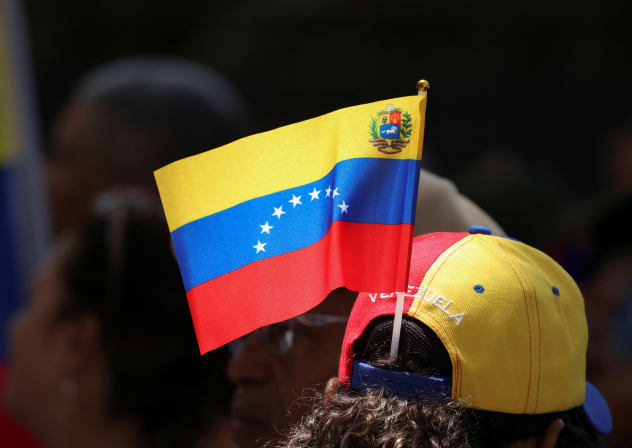 A supporter of opposition leader Maria Corina Machado’s Vente Venezuela wears a Venezuelan flag during a rally marking the two-year anniversary of presidential elections, which authorities said Nicolas Maduro won, in Caracas, Venezuela, July 28, 2026. 