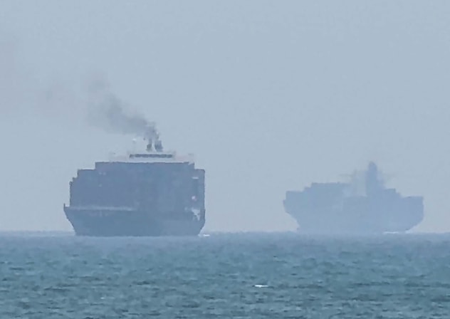 This frame grab taken from AFPTV video footage on July 12, 2026 shows cargo ships anchoring near the Strait of Hormuz; illustrative