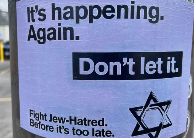A poster against antisemitism is seen on the International Day for the Elimination of Racial Discrimination in Markham, Ontario, Canada on March 22, 2025.