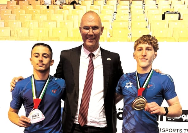 NEWLY CROWNED world champion Guy Torres (left) and silver medalist Shalev Snir (right) pose with Israeli Ambassador to the United Arab Emirates Yossi Shelley during the medal ceremonies at the Junior World Jiu-Jitsu Championships in Abu Dhabi.