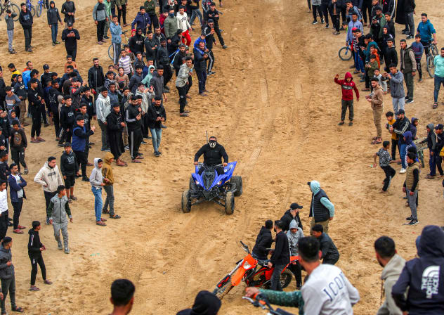 Illustrative: A man performs stunts with an all-terrain vehicle (ATV) on sand dunes near destroyed buildings in the Zahra neighbourhood, southwest of Nuseirat in the central Gaza Strip, on February 6, 2026.