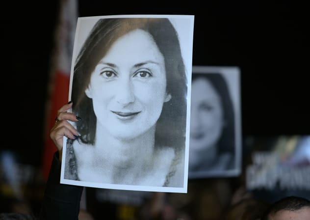 Protesters hold pictures of the late journalist Daphne Caruana Galizia as they gather outside the prime minister's office to call for his resignation, in Valletta, Malta on November 20, 2019, the day Maltese businessman Yorgen Fenech was detained on his yacht after he tried to leave Malta.