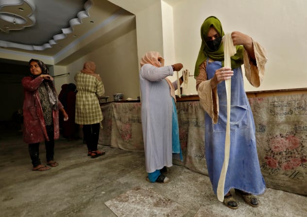 Afghan women prepare dough to make traditional cookies inside a bakery in Kabul, Afghanistan, May 5, 2024.