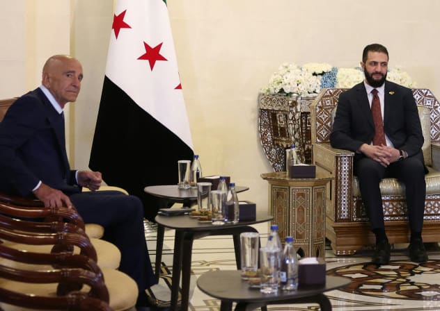 Syria's interim President Ahmad al-Sharaa (R) receives US Special Envoy to Syria Thomas Barrack, at the presidential palace in Damascus, July 9, 2025