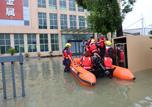 Firefighters evacuate workers from a flooded factory following heavy rains in Wenling city, Taizhou eastern China's Zhejiang province on August 12, 2026. (Illustrative)