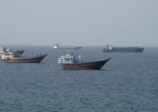 Vessels near the Strait of Hormuz, as seen from Musandam, Oman, August 17, 2026. 