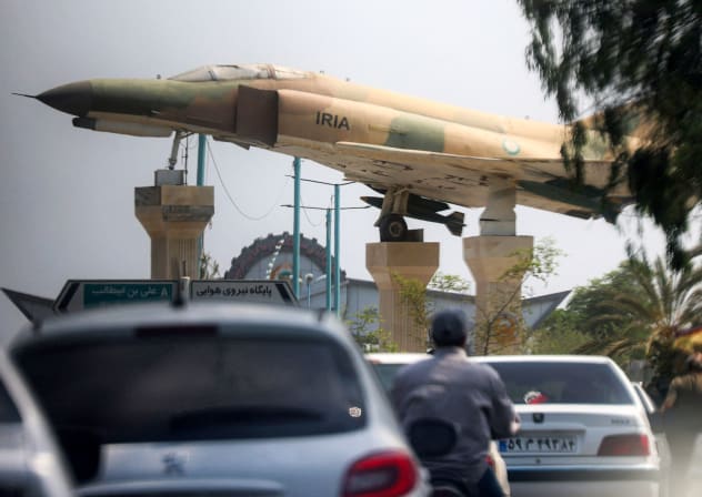  replica of an Iranian air force F-4 Phantom fighter aircraft is displayed before traffic along a city square in Bandar Abbas in southern Iran on August 10, 2026. 