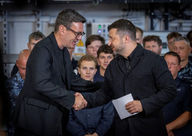 British Prime Minister Andy Burnham interacts with the President of Ukraine, Volodymyr Zelensky, during their visit to Portsmouth Naval Base to meet UK and Ukrainian troops, July 27, 2026. 