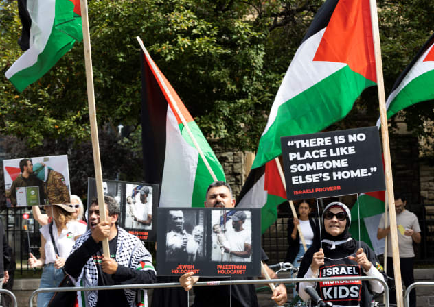 Pro-Palestinian protestors wave flags and signs across the street of the Roy Thomson Hall where the documentary "The Road Between Us: The Ultimate Rescue" is screened during the Toronto International Film Festival (TIFF) in Toronto, Ontario, on September 10, 2025; illustrative