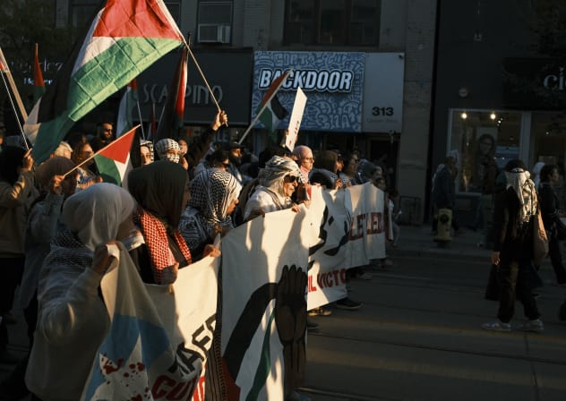 Hundreds of pro-Palestine activisits, carrying the flags of Palestine and Lebanon, march in Toronto, Canada, on October 20, 2024 to show solidarity with Palestinians.