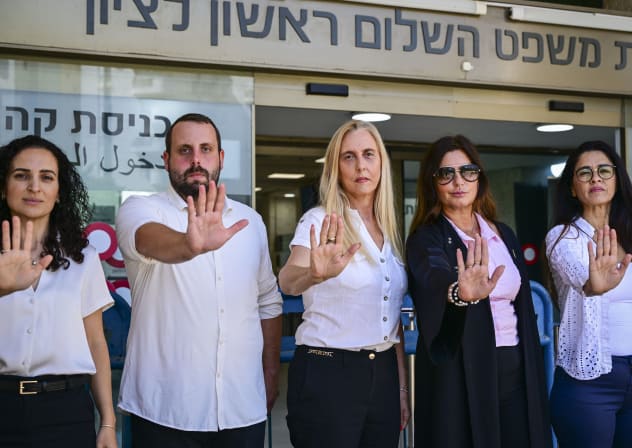 Friends and colleagues of attorney Arbel Feldman stand in his memory outside a remand hearing for suspected killer Ahmad al-Rajoub at the Rishon Lezion Magistrate's Court earlier this month.