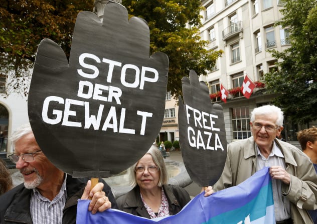 Protestors display posters demanding 'Stop the violence' and 'Free Gaza' during a demonstration for peace in Palestine, in Zurich 2014.