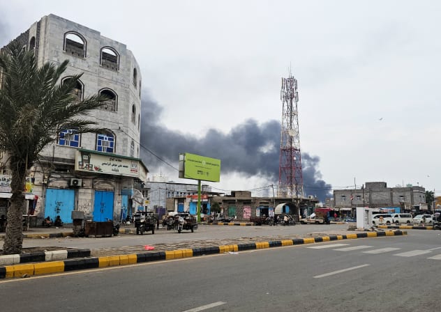 Smoke rises during Houthi missile and drone strikes on the Red Sea port city of Mocha, Yemen, August 9, 2026. Picture taken with a mobile phone. 
