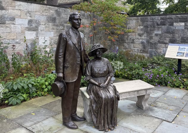 Statues of Henry and Clara Ford look over the garden at their historic Fair Lane home in Dearborn, Michigan, Sept. 2, 2026.