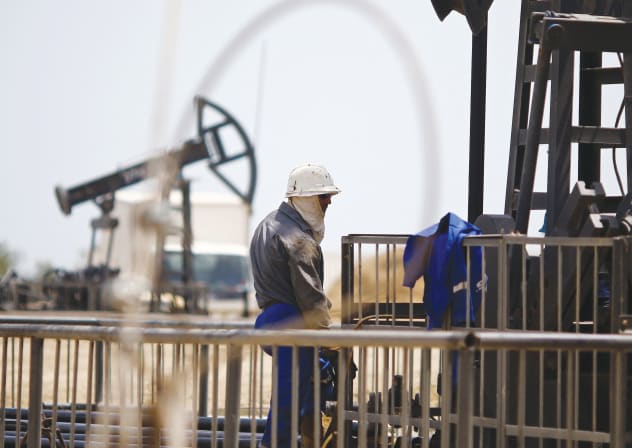 A WORKER rests next to an oil pump in Baku, Azerbaijan. 