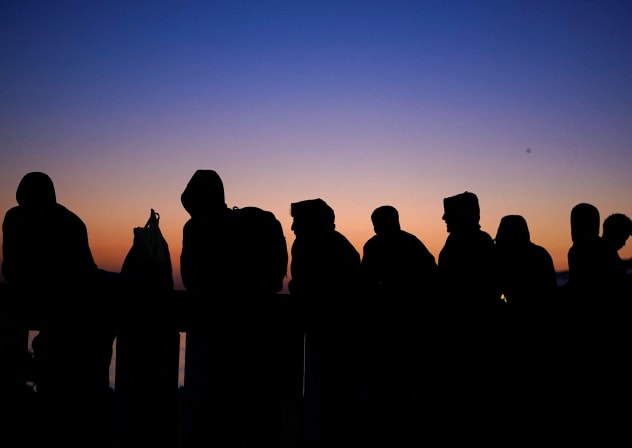 People wait for relocation at Benitez beach settlement following the mass crossing of migrants from Morocco, in Ceuta, Spain, September 16, 2026.