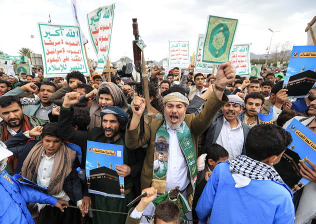 Supporters of the Houthis brandish their weapons during a protest against the Saudi intervention in Yemen and against Saudi Arabia after the Houthis fired at the holy city of Mecca, in Sanaa on September 18, 2026. 