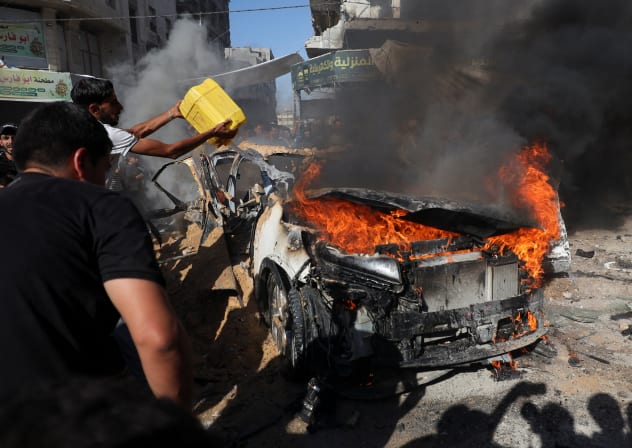 Palestinians attempt to extinguish a fire following an Israeli air strike that hit a vehicle in Gaza City, September 19, 2026.