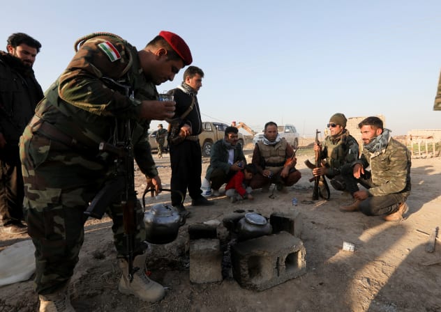 Iraqi forces and Kurdish Peshmerga fighters gather during a security deployment in Luhaiban village in Kirkuk Monday, 6th December 2021