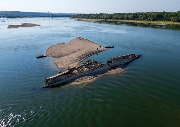 This aerial photograph shows the wreckage of a World War II German warship, one of dozens sunk by retreating Nazi forces in September 1944, emerging from the low waters of the Danube River near Prahovo, Serbia, on August 11, 2026.