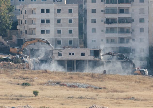 BULLDOZERS DEMOLISH a Palestinian building in Kafr Akab, near Jerusalem in the West Bank, in June 2026.