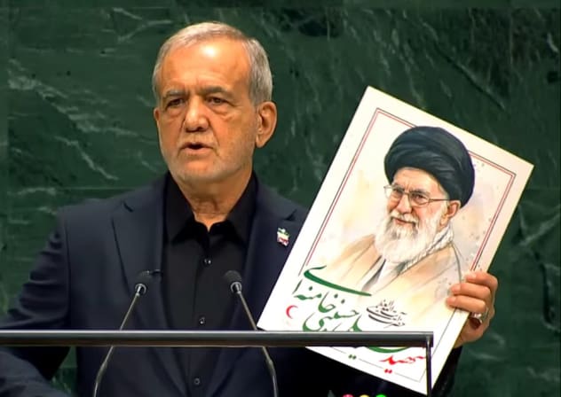 Iranian President Masoud Pezeshkian holds a memorial flyer for former Iranian supreme leader Ayatollah Ali Khamenei during his UN General Assembly address in New York, September 23, 2026.