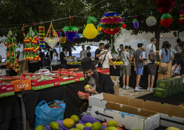 Jews shop at a “Four Species” market outside the Mahane Yehuda Market in Jerusalem, ahead of the Jewish holiday of Sukkot, September 22, 2026.