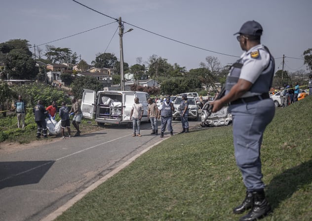 Illustrative: South African Police Service ( SAPS) officers watch forensic pathology personnel assisted by community members load the bodies of victims into a mortuary van following a mass shooting in the Ziko area of KwaMakhutha, south of Durban on September 23, 2026.