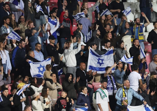 ISRAEL FANS at Nagyerdei Stadion, Debrecen, Hungary, wave flags after the match of the blue-and-white 3-0 loss to Ireland in Nations League action.