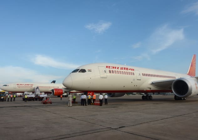 Air India's first Boeing 787 Dreamlinter (R) aircraft from Charleston, USA, is parked on the tarmac at Indira Gandhi International airport's terminal T-3 in New Delhi, on September 8, 2012.