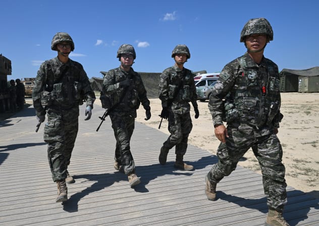 South Korean Marines walk across a training area during a Combined Joint Logistics Over-the-Shore (CJLOTS) and Combat Service Support Area (CSSA) operations as part of a joint field training exercise conducted by South Korea-US Combined Forces Command in Pohang on July 15, 2026. 