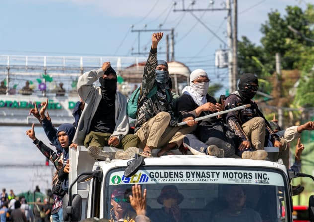 Supporters of a political group cheer after destroying a vehicle believed to contain firearms during the first parliamentary elections of the Bangsamoro Autonomous Region in Muslim Mindanao (BARMM), outside Sero Central Elementary School, Cotabato City, Philippines, September 14, 2026.