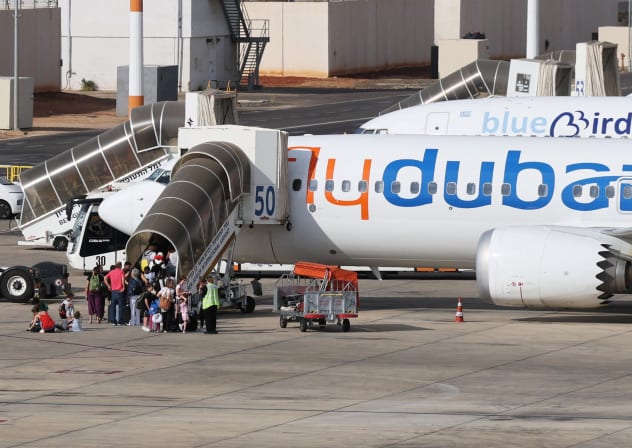 Travelers board a flydubai aircraft at Ben Gurion International Airport after a separate FlyDubai flight from the United Arab Emirates to Israel was diverted to Saudi Arabia following an emergency signal, on September 30, 2026.
