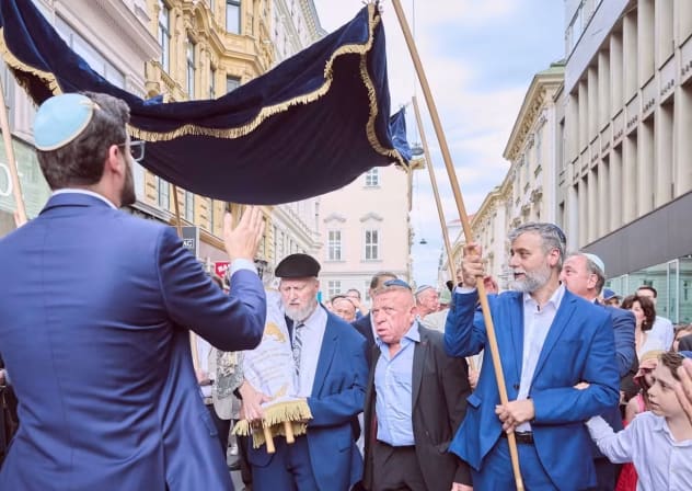 Vienna Jews celebrating the renovation of the Stadttempel synagogue walk a new Torah scroll through the streets, Vienna, Sept. 9, 2026.