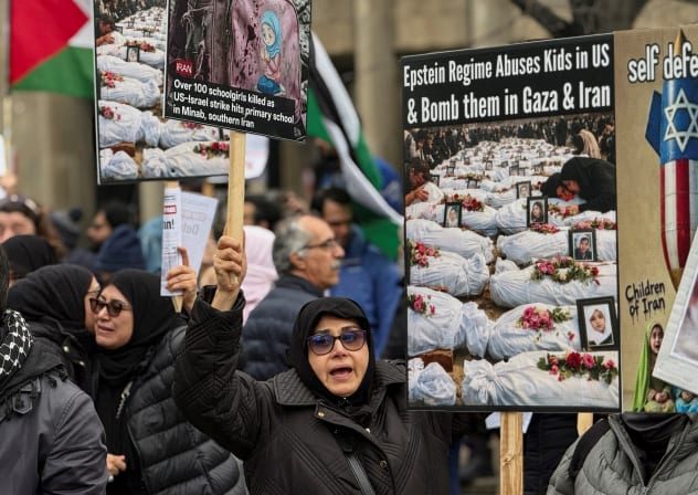 Counter-protester holds signs against the U.S.-Israel conflict with Iran in Toronto Saturday, 7th March 2026