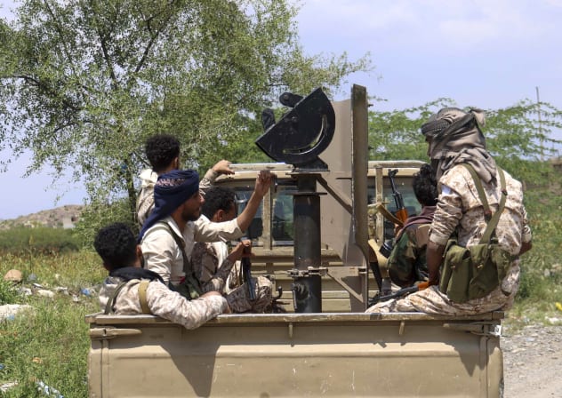 Saudi-backed Yemeni government forces ride in the back of a military truck at the Jabal Han front west of the city of Taiz following fierce battles earlier in the day as Yemen's Houthis reportedly attempted to seize control of the main route between the inland city of Taiz and Aden.